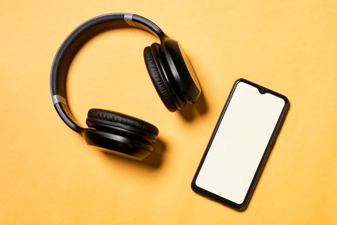 black-music-headphones-and-smartphone-on-yellow-background